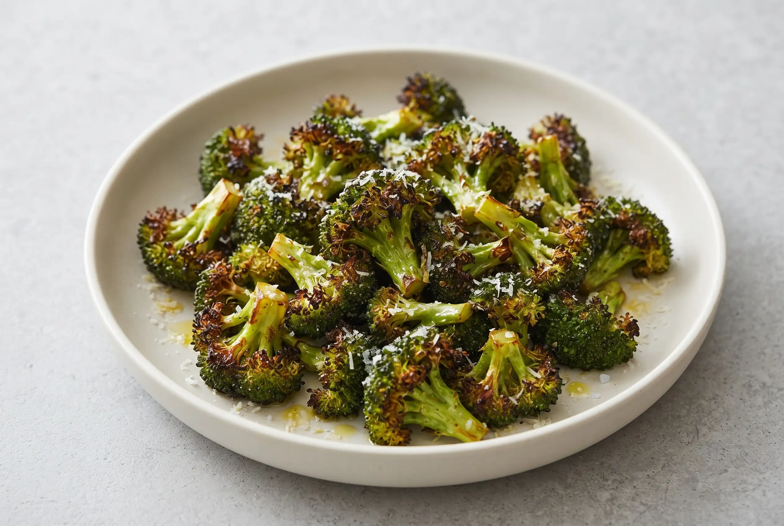 Air fryer broccoli with tender green florets and browned roasted edges in a bowl