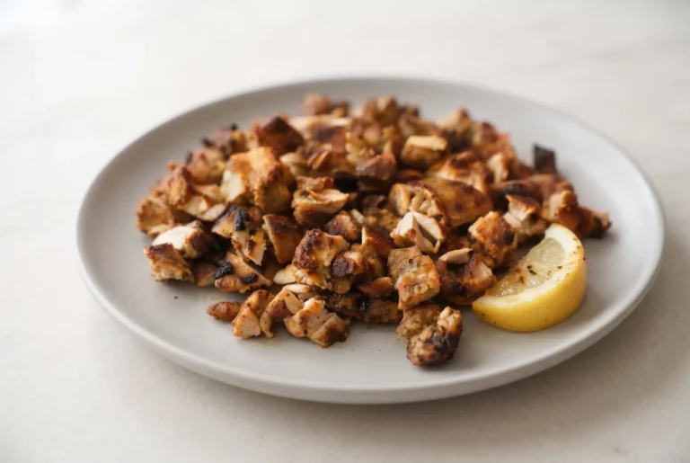 Air fryer chicken thighs with paprika seasoning and lemon served on a plate
