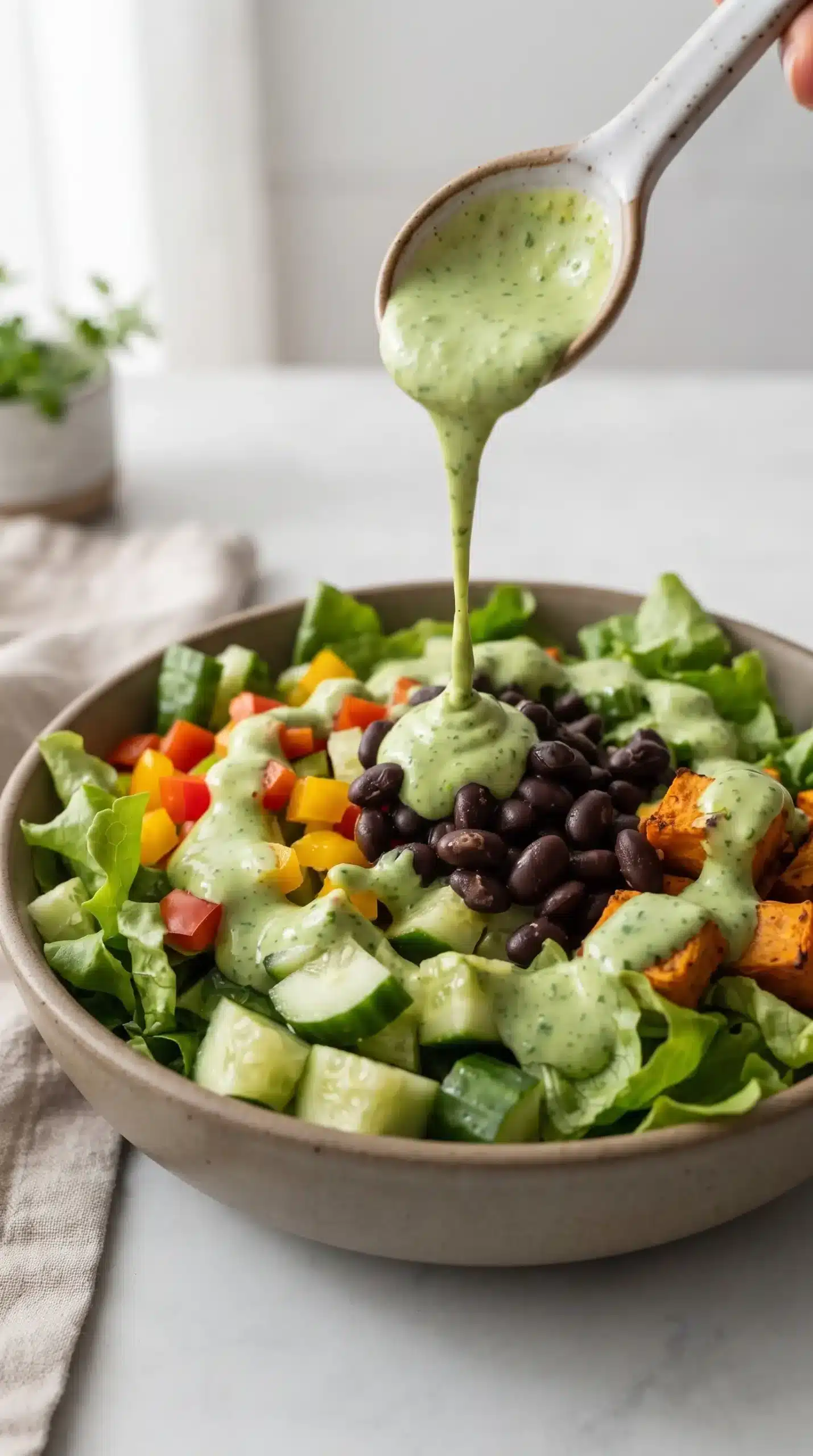 Avocado cilantro dressing drizzled over a fresh vegetable salad