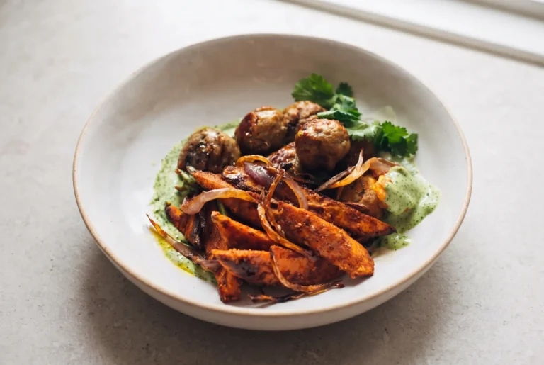 Avocado mojo bowl with sweet potato, chicken meatballs, roasted onion, and creamy green avocado sauce