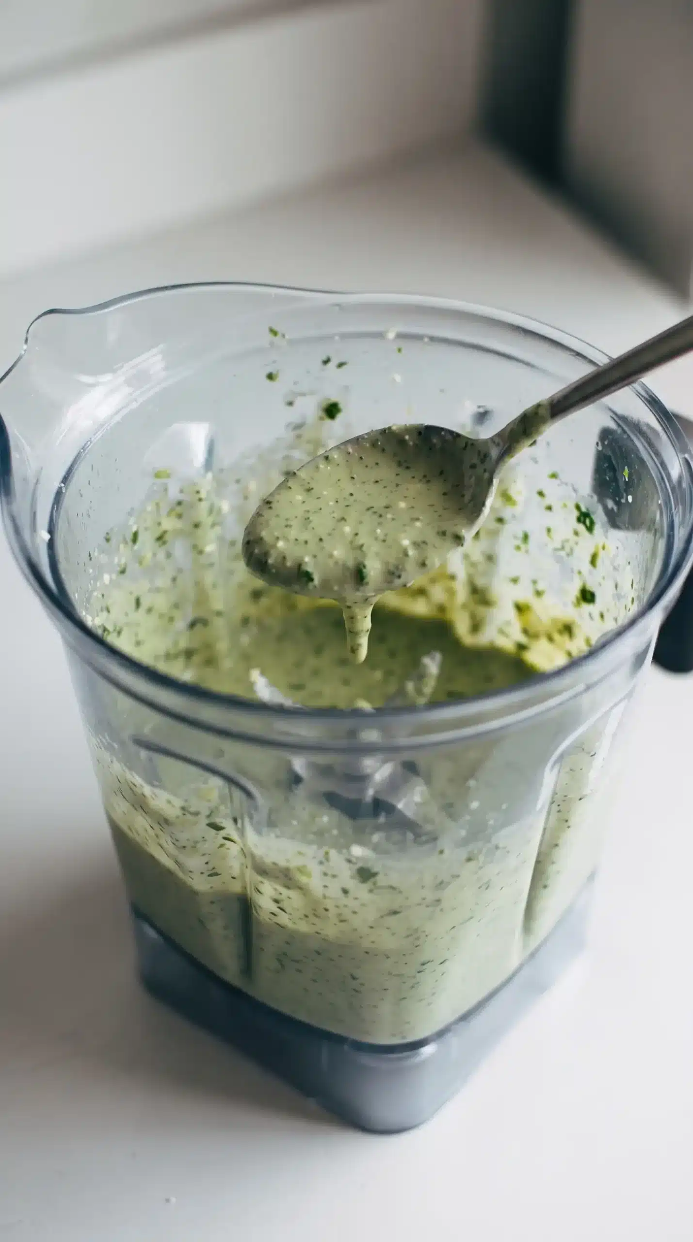 Blended aji verde sauce showing creamy texture with cilantro and cheese flecks