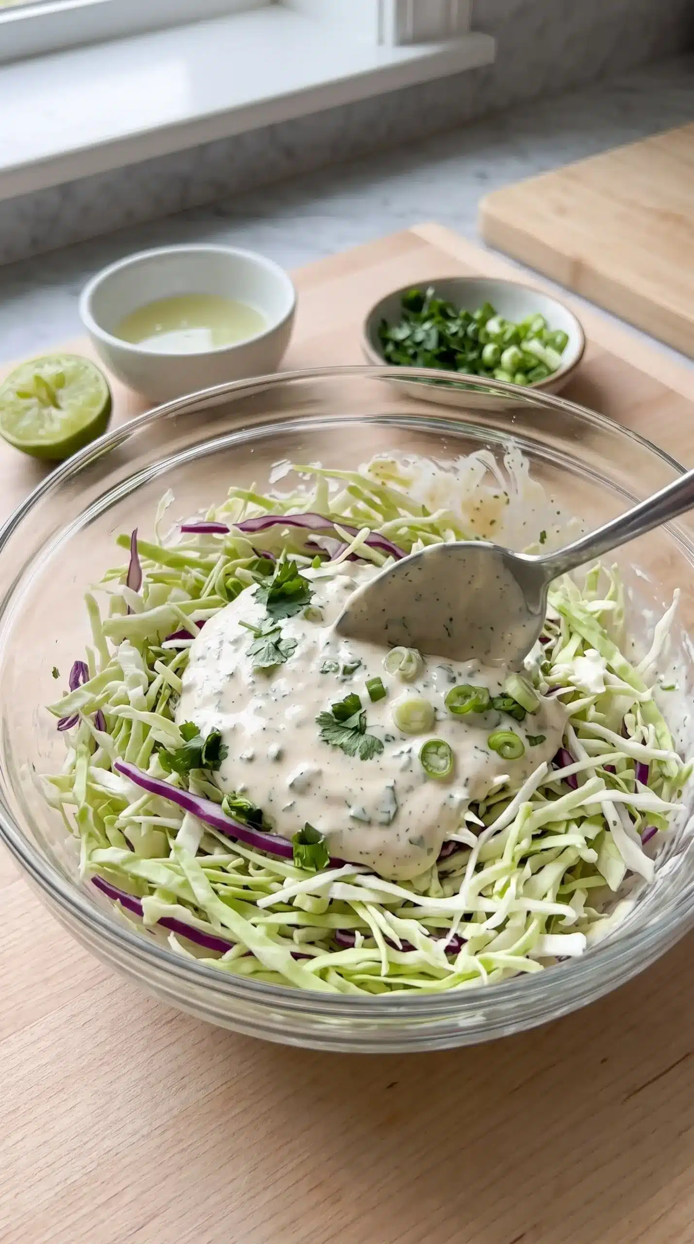 Creamy lime cabbage topping mixed with herbs for fish tacos