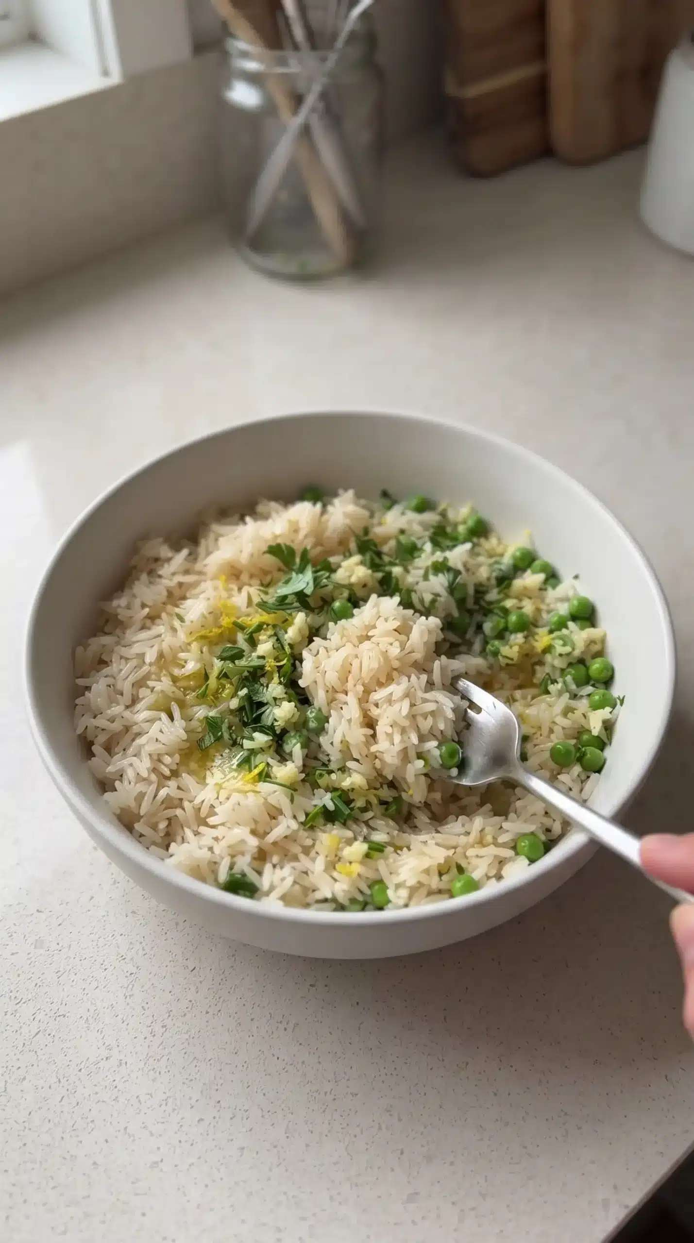Jasmine rice mixed with peas, lemon zest, herbs, garlic, and butter